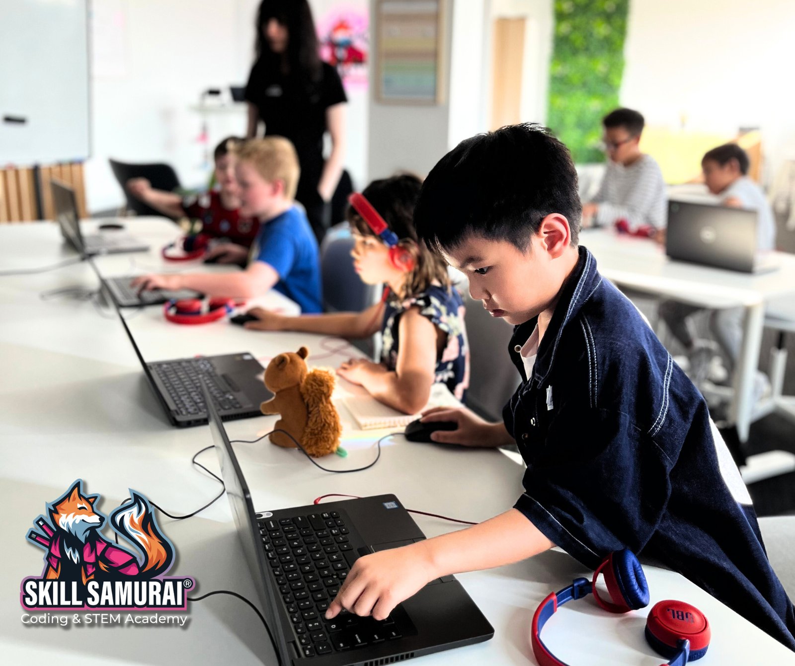 A student working at a laptop during a Skill Samurai class